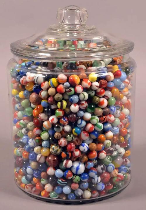 A guessing game, where the objective is to guess the number of marbles/candy inside an object